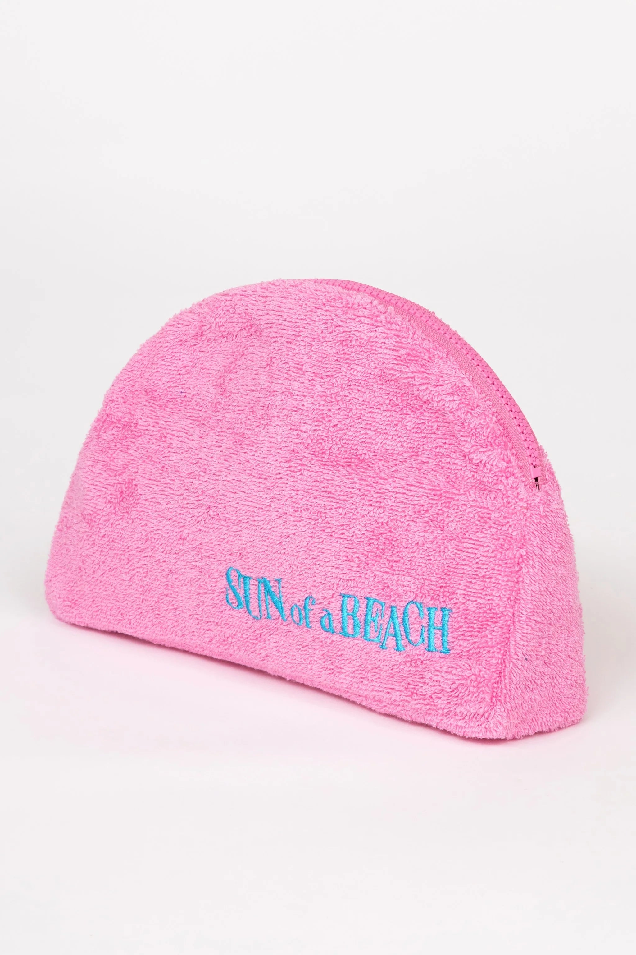 Pink beanie with 'Sun of a Beach' text on a white background
