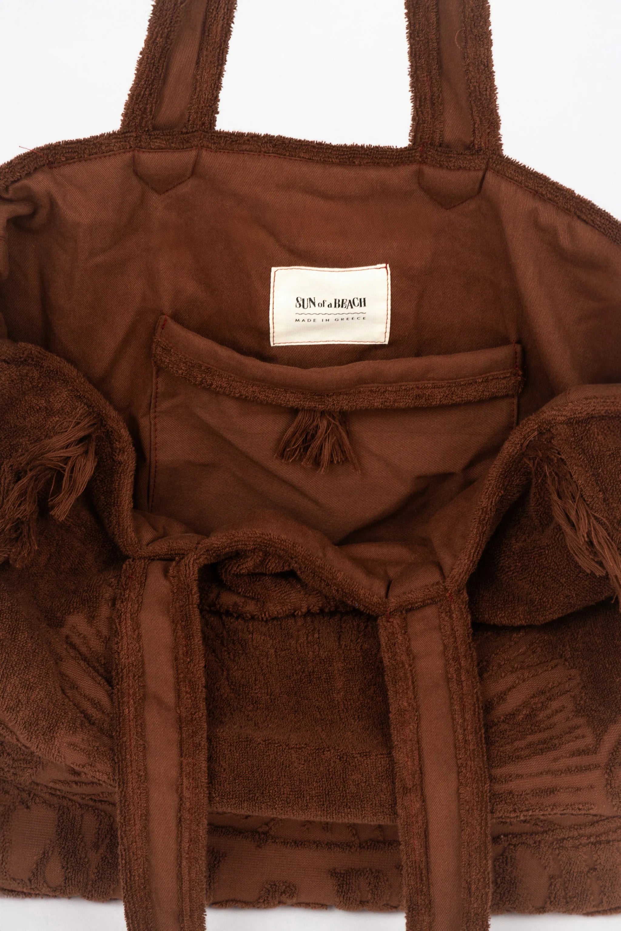 Brown textured bag with a visible brand label on a white background