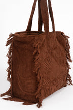 Brown suede handbag with fringe details on a white background