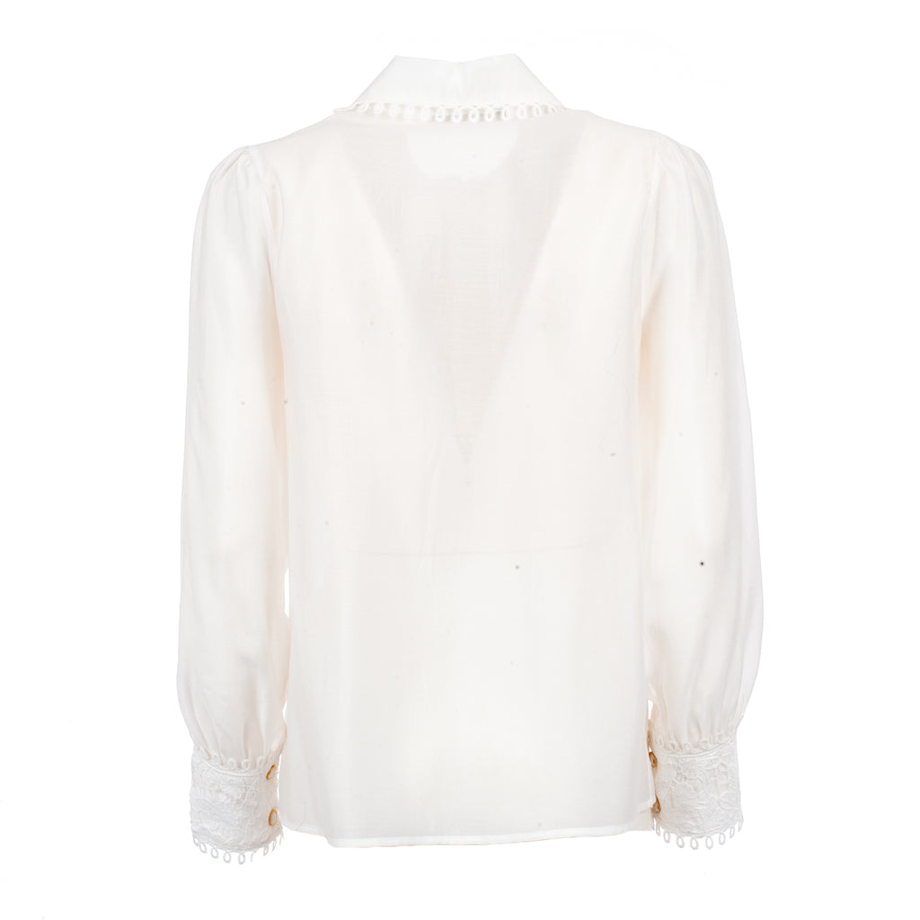 White blouse with ruffled details on a white background