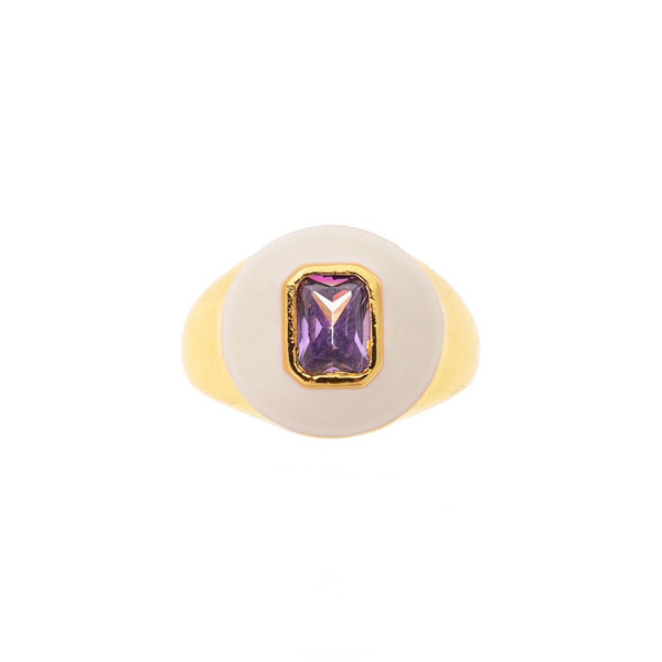 Ring with a gold band and purple gemstone on a white background