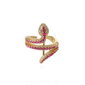 Gold and pink snake-shaped ring on a white background