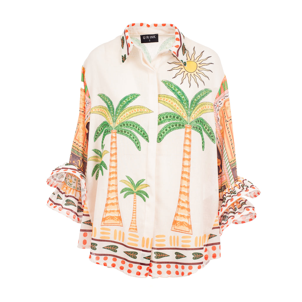 Colorful blouse with palm tree and sun design on a white background