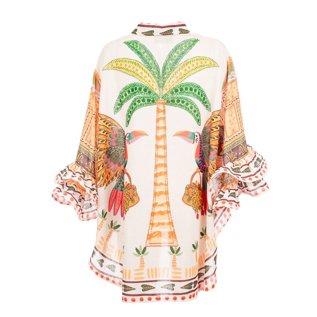 Colorful dress with palm tree and toucan design on a white background