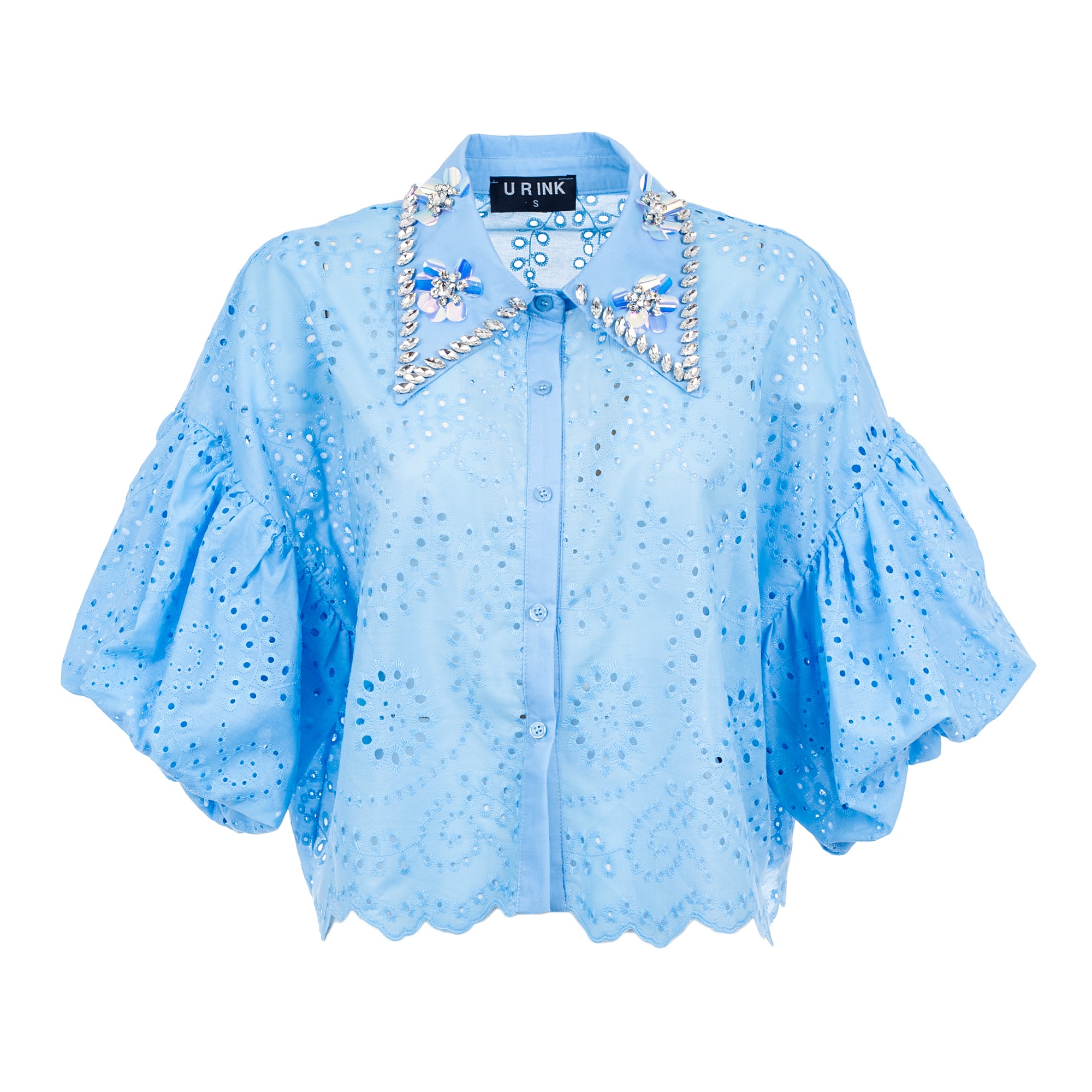 Light blue blouse with decorative elements on a white background