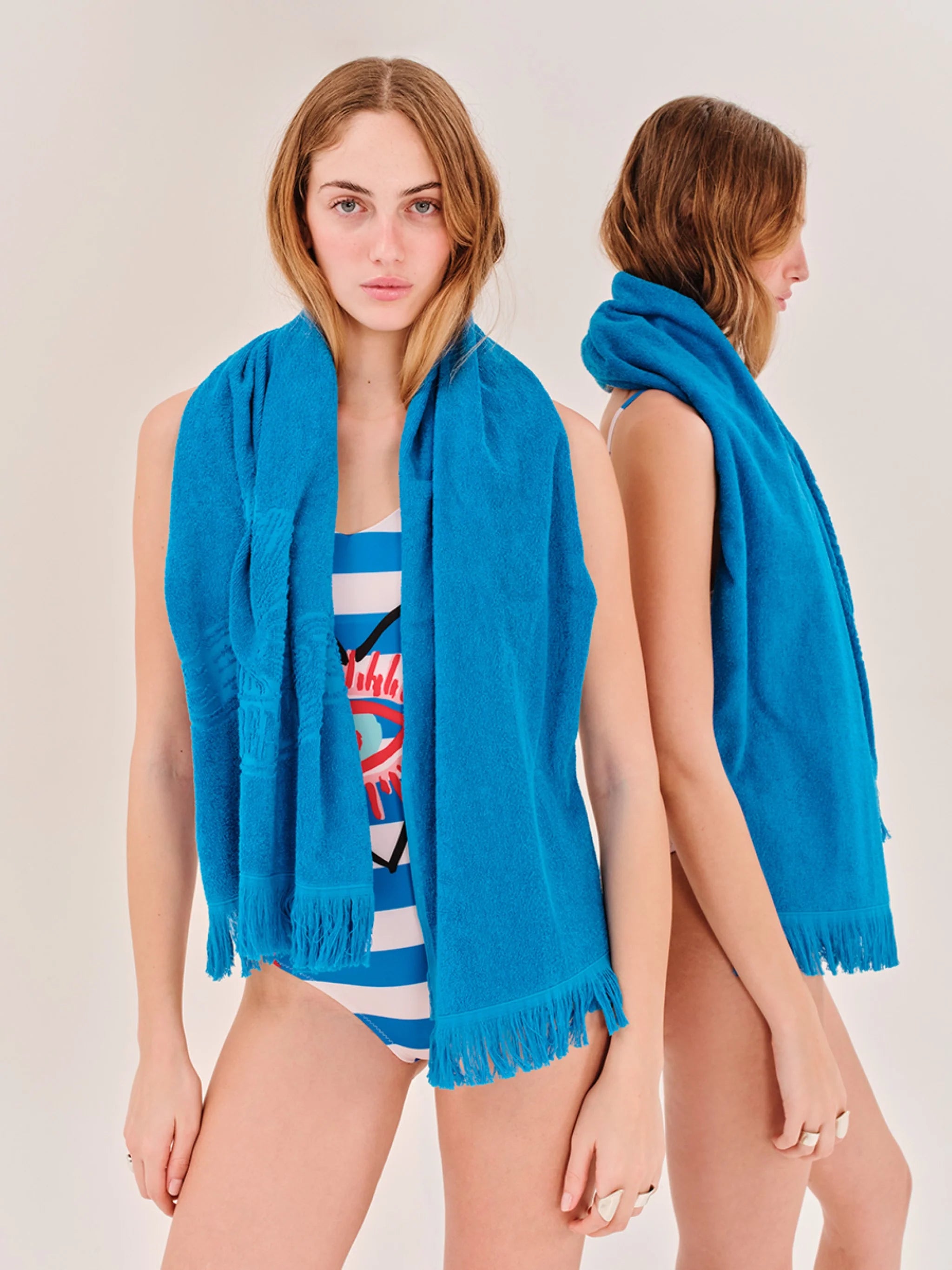 Woman wearing a blue scarf with a white background