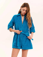 Woman wearing a blue robe against a white background