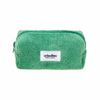 Green towel with a white label on a white background