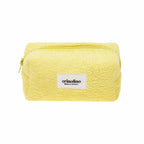 Yellow textured pouch with a visible brand label on a white background