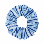 Blue and white striped scrunchie with bow pattern on a white background