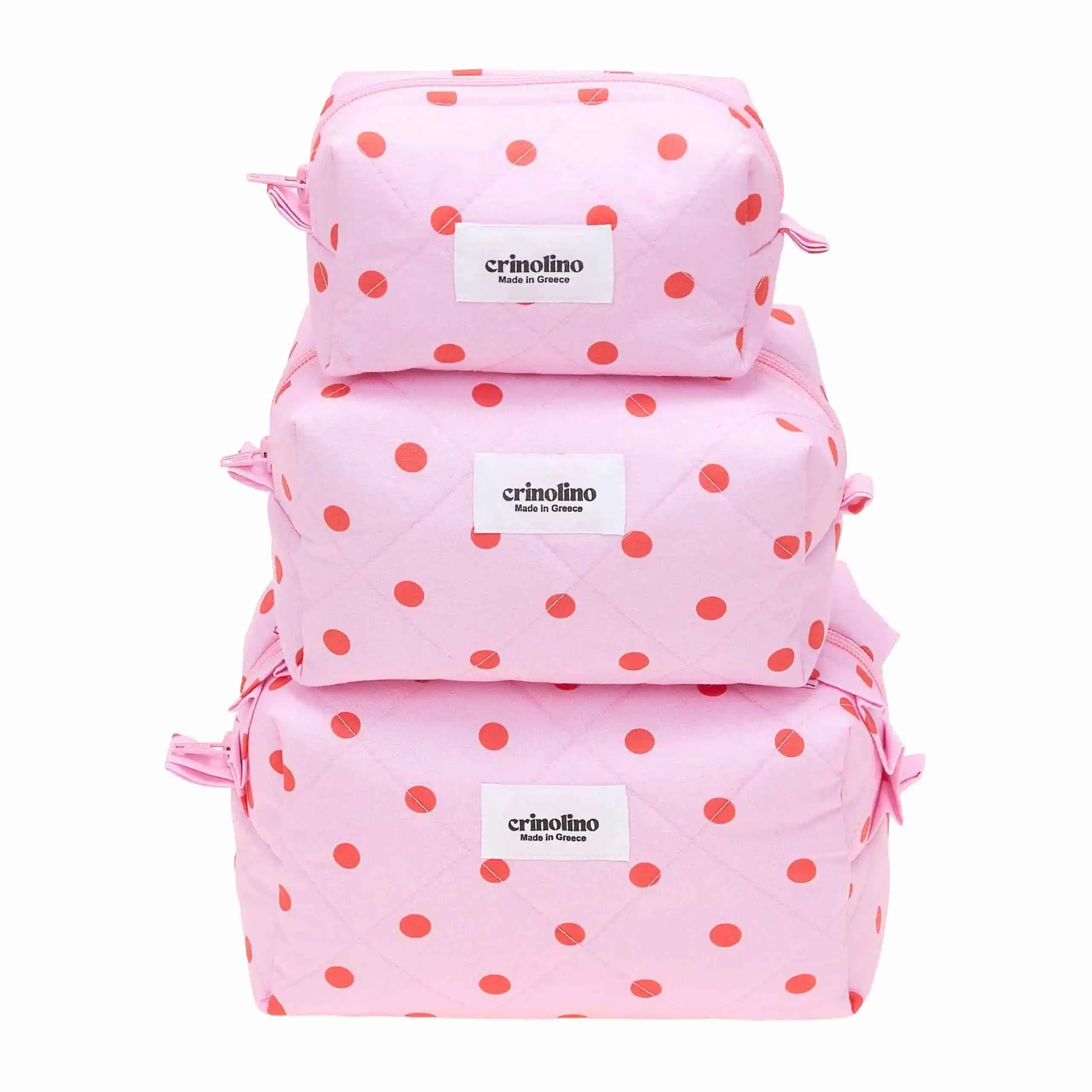 Pink polka dot backpacks with 'crinolino' label on a white background