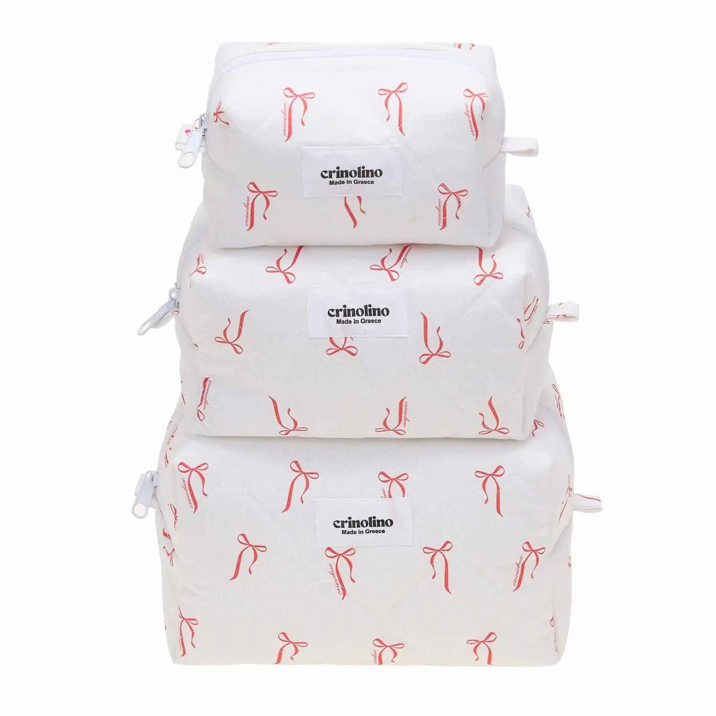 Three white bags with red bow patterns stacked on a white background, featuring the 'crinolino' brand.