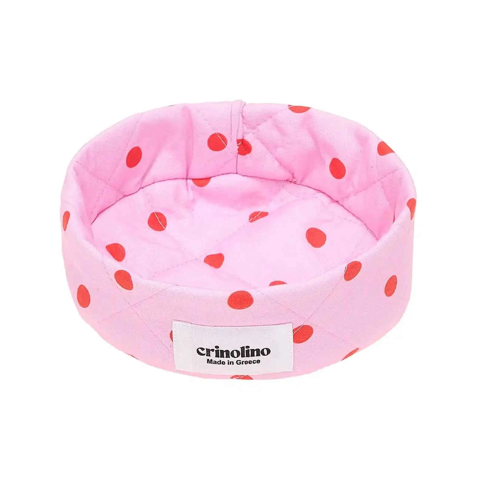 Pink polka dot chair with 'crinolino' label on a white background