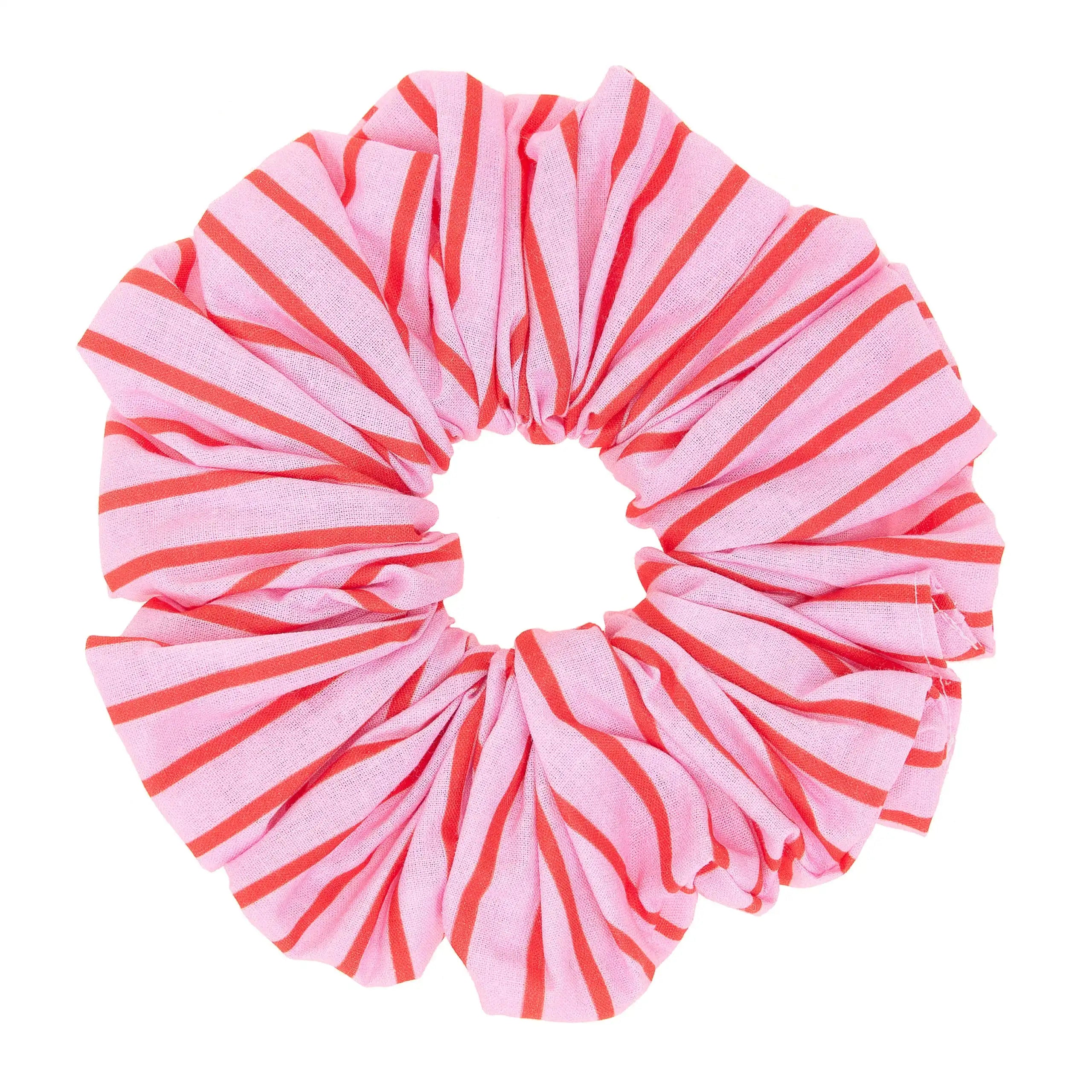 Pink and red striped scrunchie on a white background
