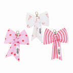 Three decorative bows with polka dots and stripes on a white background
