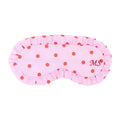 Pink eye mask with red polka dots and initials 'MS' on a white background