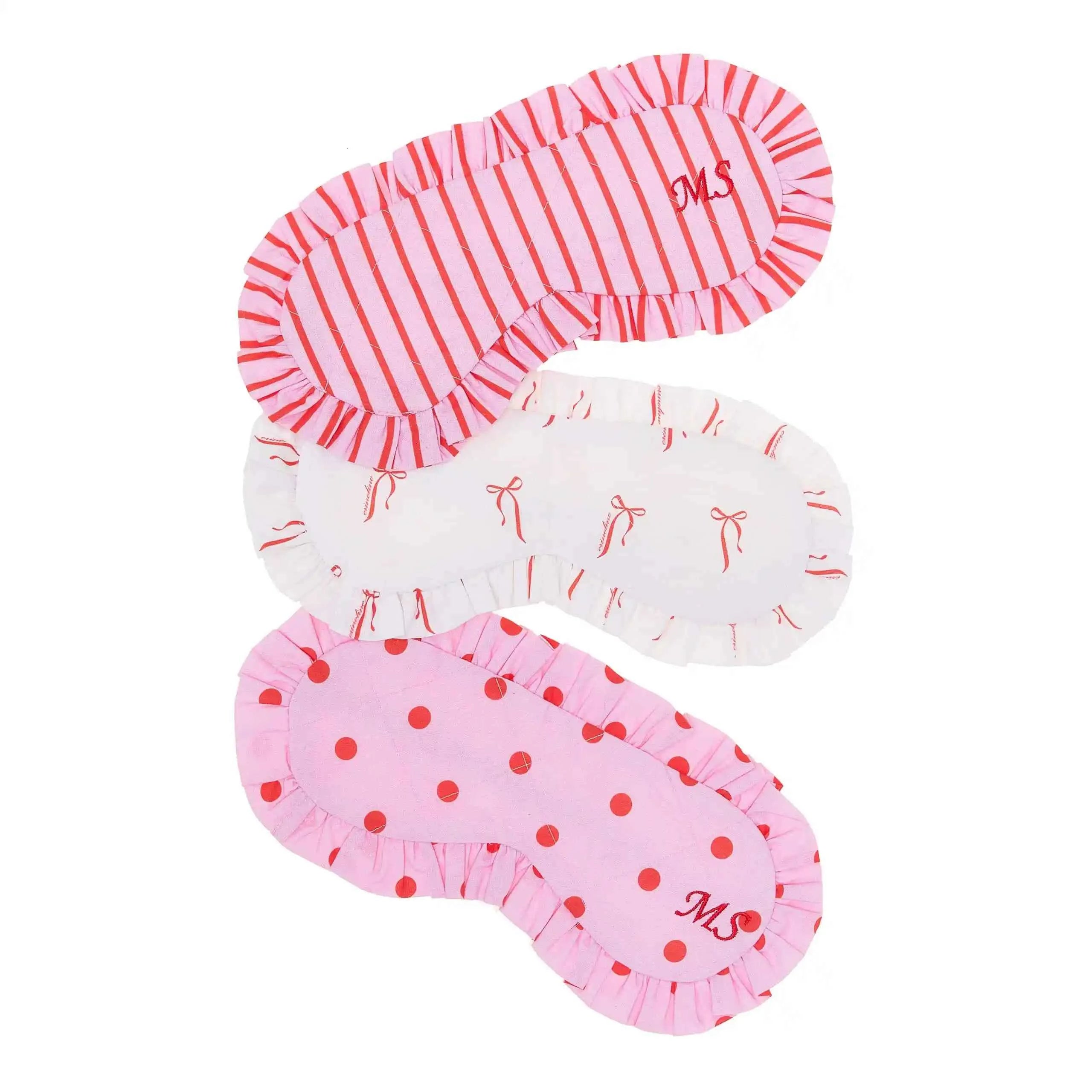Set of three pink and white eye masks with different patterns on a white background