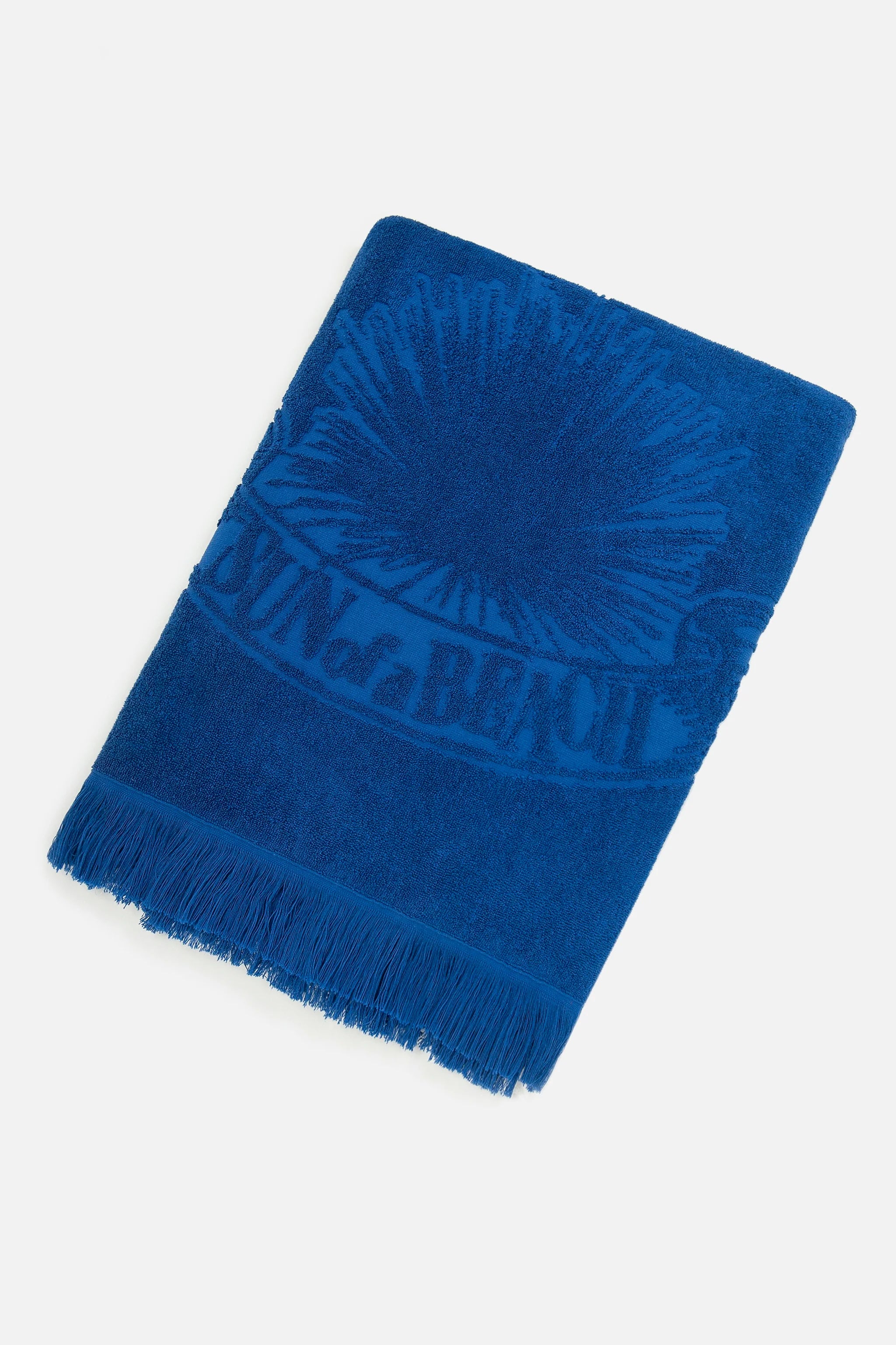 Blue textured blanket with fringes on a light gray background
