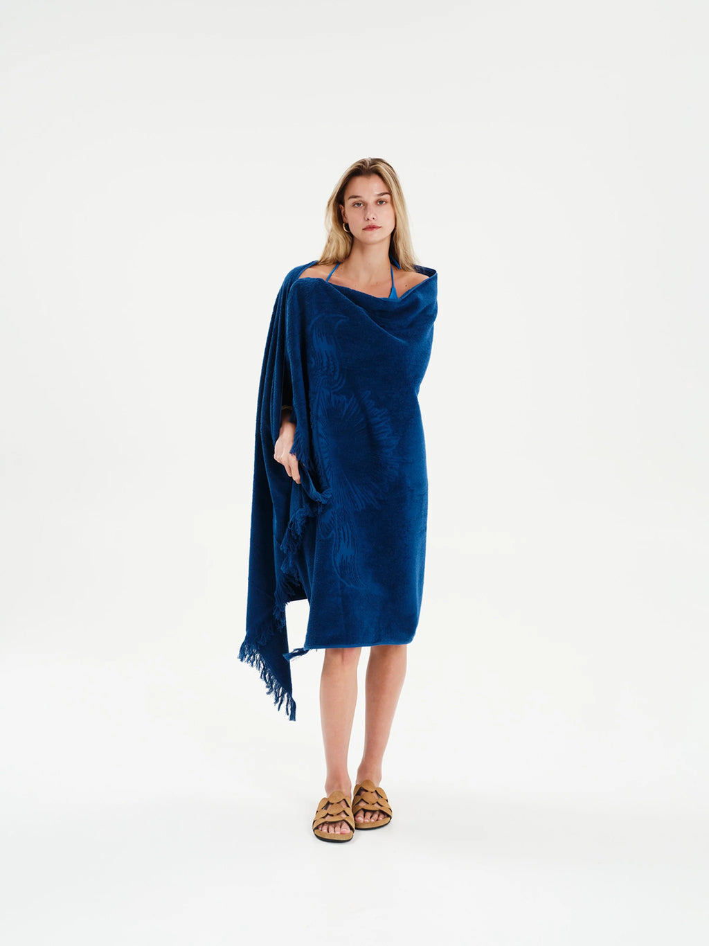 Woman wearing a blue poncho on a white background
