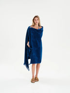 Woman wearing a blue poncho on a white background