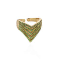 Gold ring with green gemstones on a white background