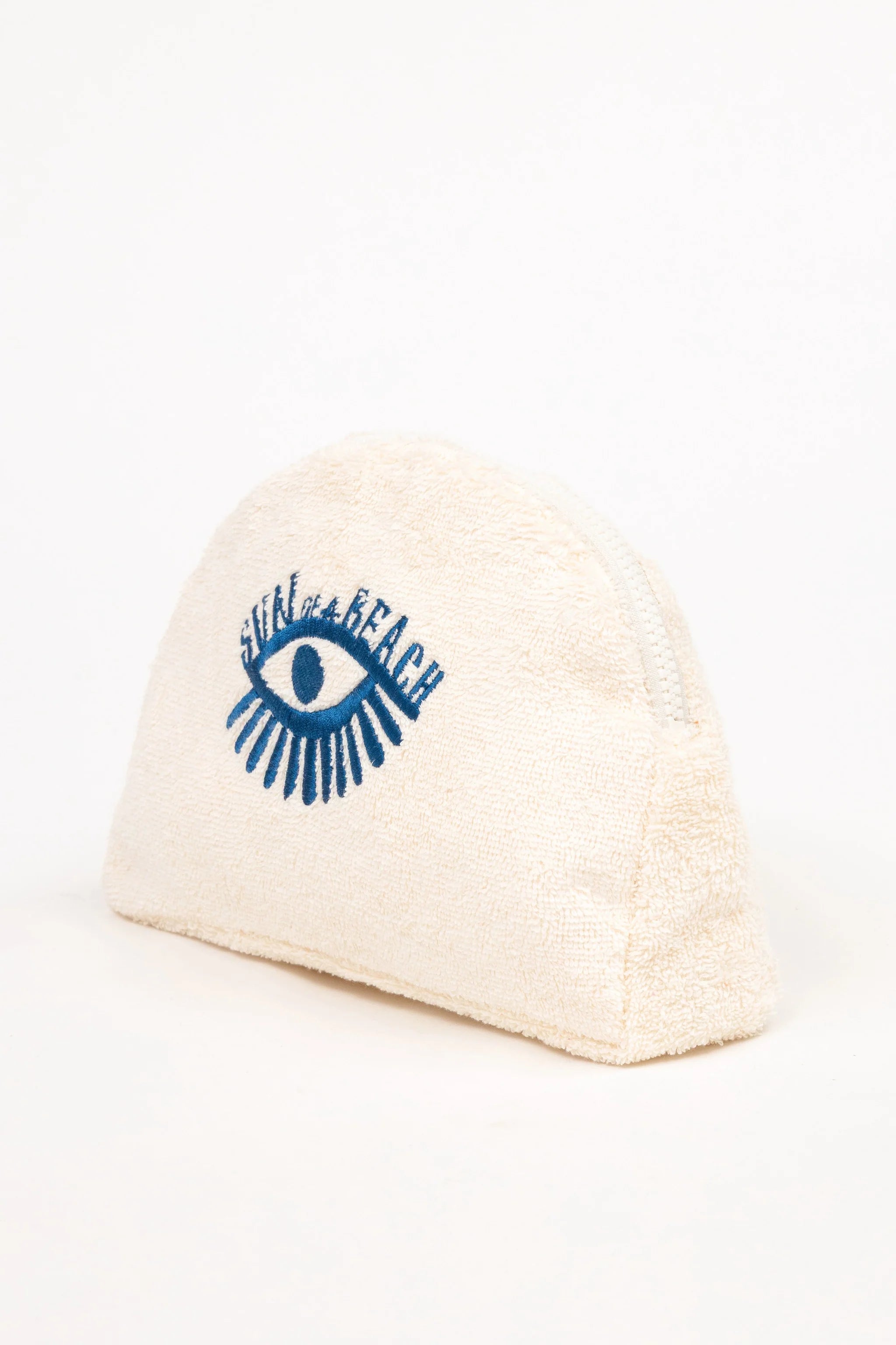 Beige beanie with blue eye design and text on a white background