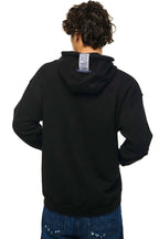 A person shown from the back wearing a black pullover hoodie and blue jeans against a plain white background.