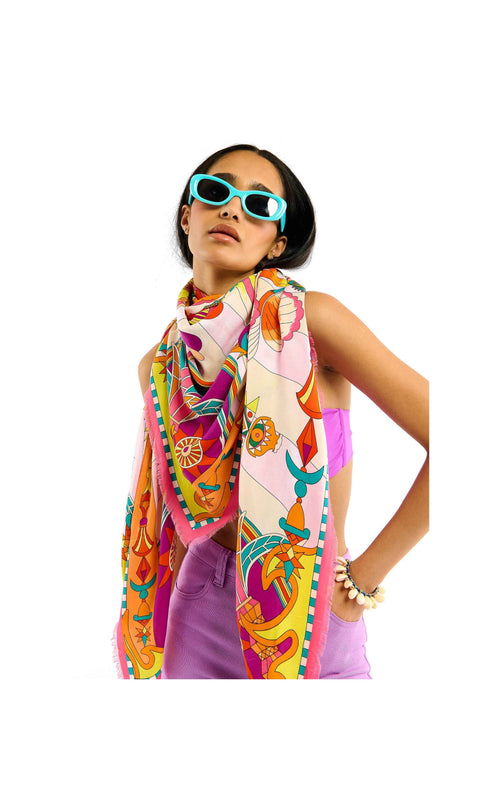Woman wearing a colorful scarf and sunglasses on a white background