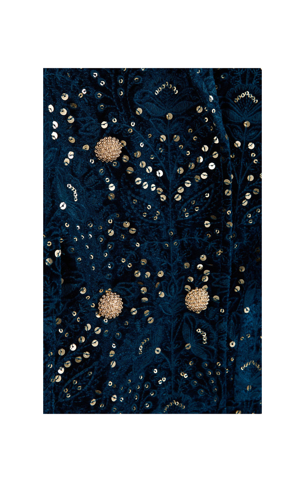 A close-up of a dark navy blue fabric with intricate gold sequin embroidery and beadwork, featuring three prominent round gold floral embellishments.