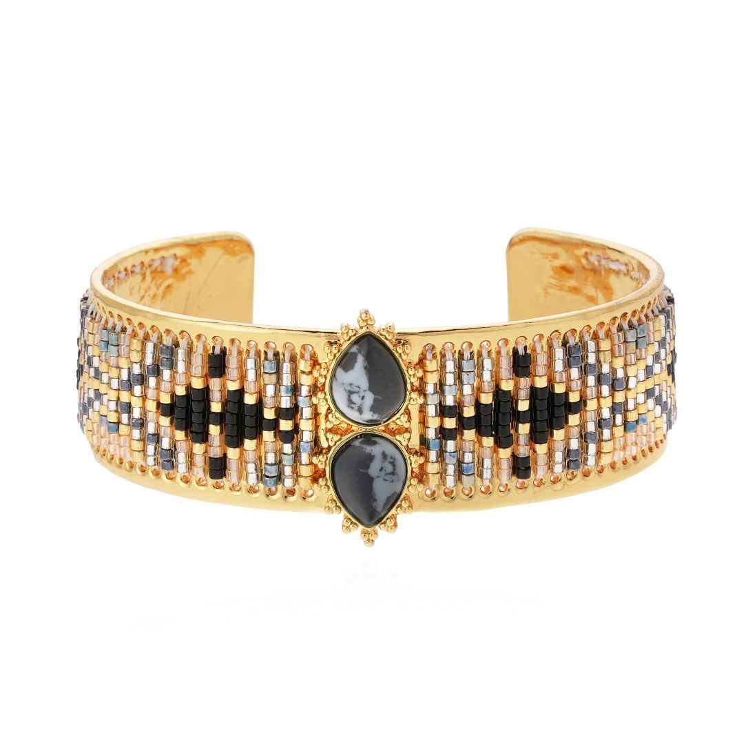Gold bracelet with black and gray stones on a white background