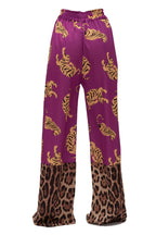 Purple pants with gold tiger pattern and leopard print at the bottom on a white background