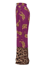 Purple pants with tiger and leopard print on a white background