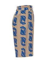 Beige pants with blue leaf pattern on a white background