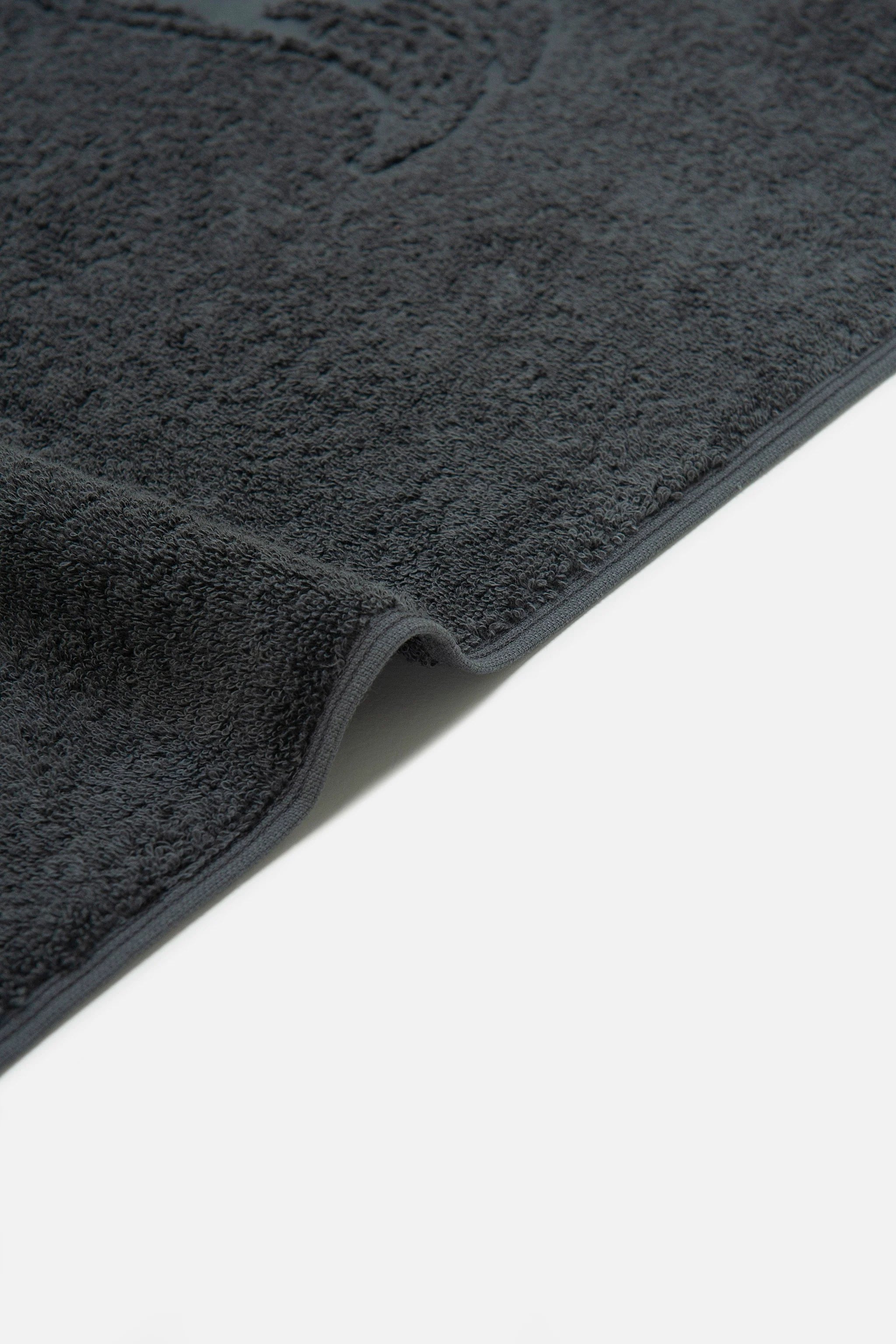 Dark gray car mat on a white background