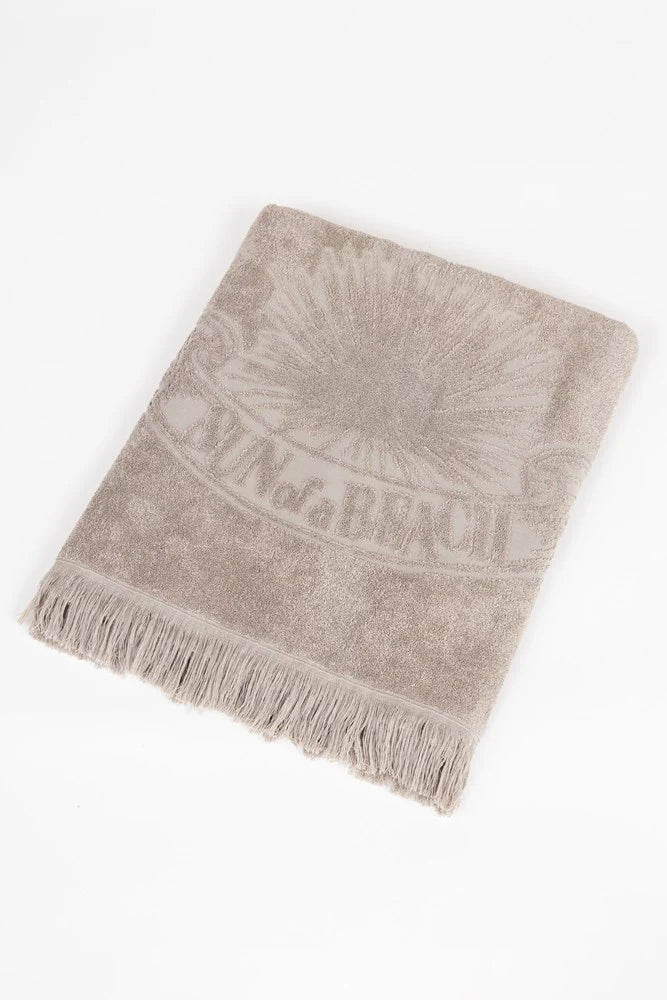 Beige towel with branding on a white background