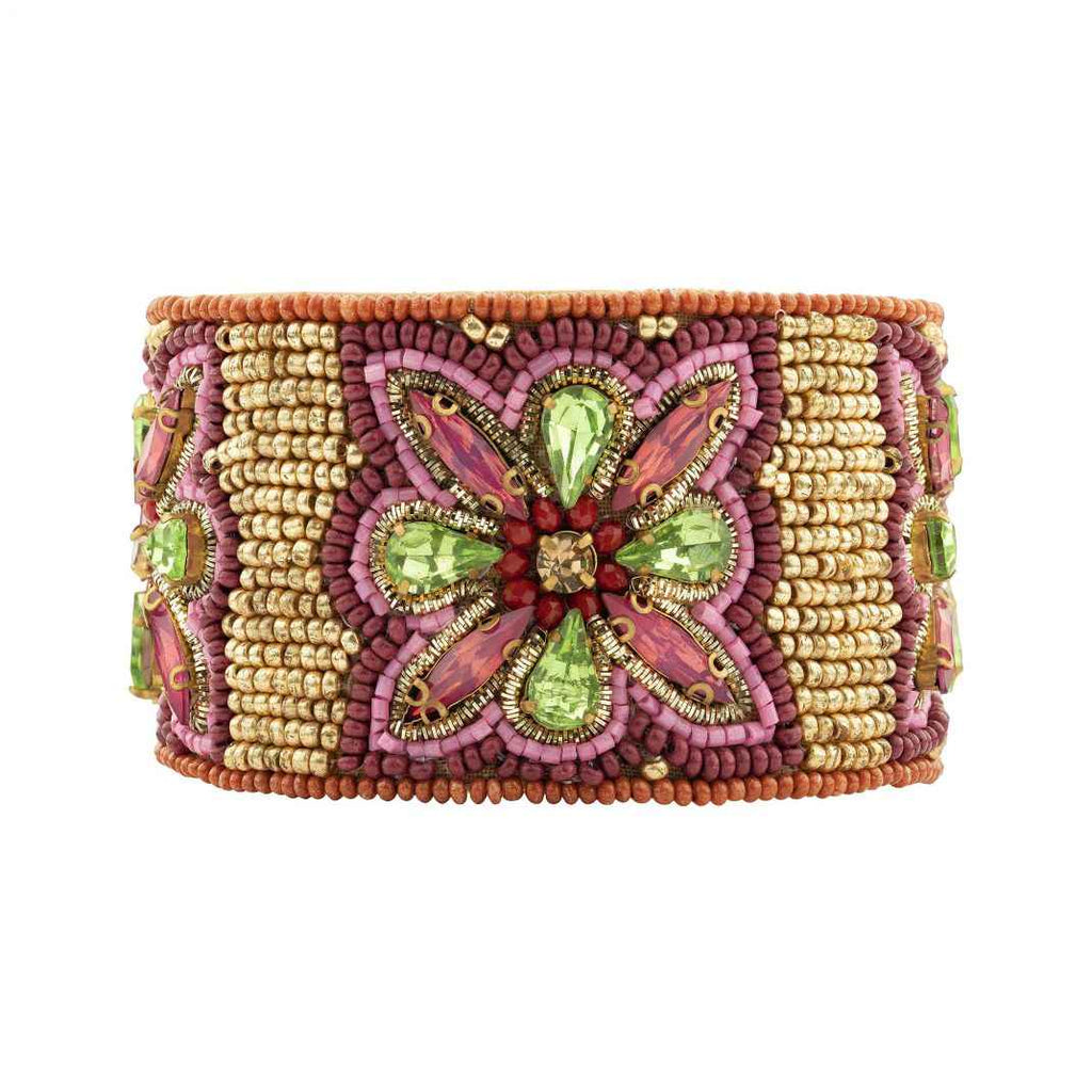 Decorative bracelet with pink, green, and gold beads on a white background