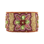 Decorative bracelet with pink, green, and gold beads on a white background