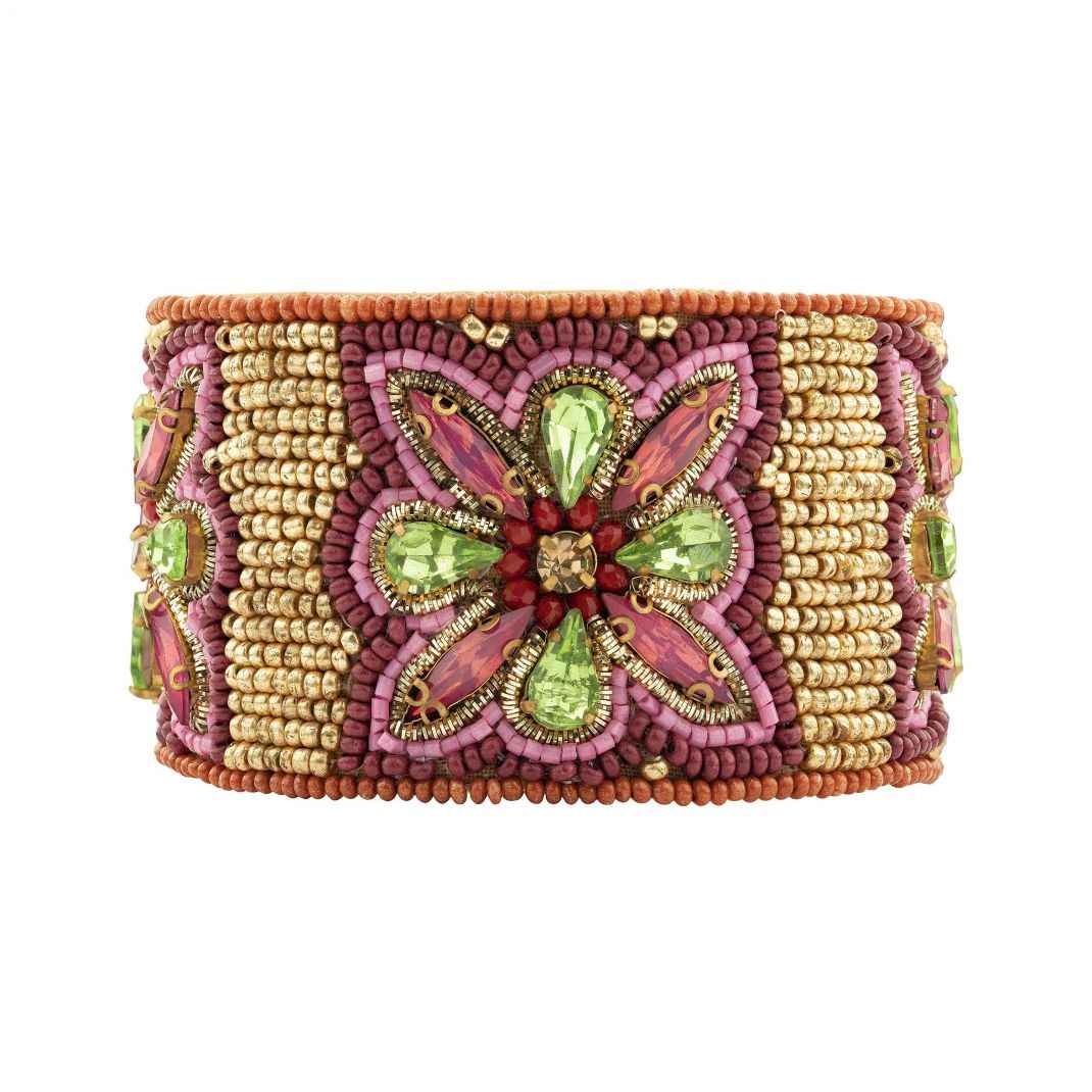 Decorative bracelet with pink, green, and gold beads on a white background
