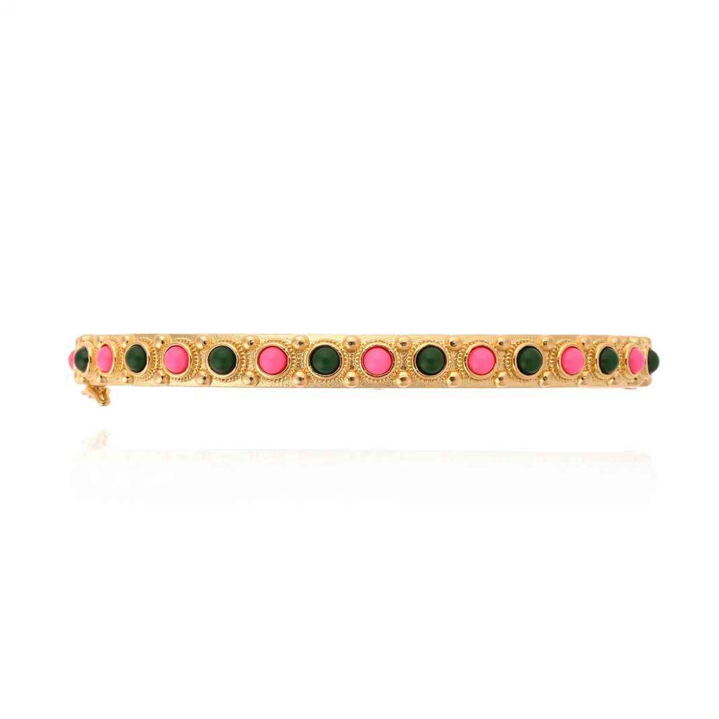 Bracelet with green and pink stones on a gold band against a white background