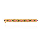 Bracelet with green and pink stones on a gold band against a white background