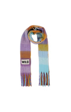 A multicolor striped scarf with fringe ends, featuring blocks of purple, orange, yellow, and light blue. A small white rectangular patch with the brand name 'WILD' is sewn onto one side.