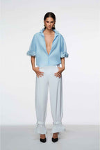 Woman wearing a light blue outfit with a white background