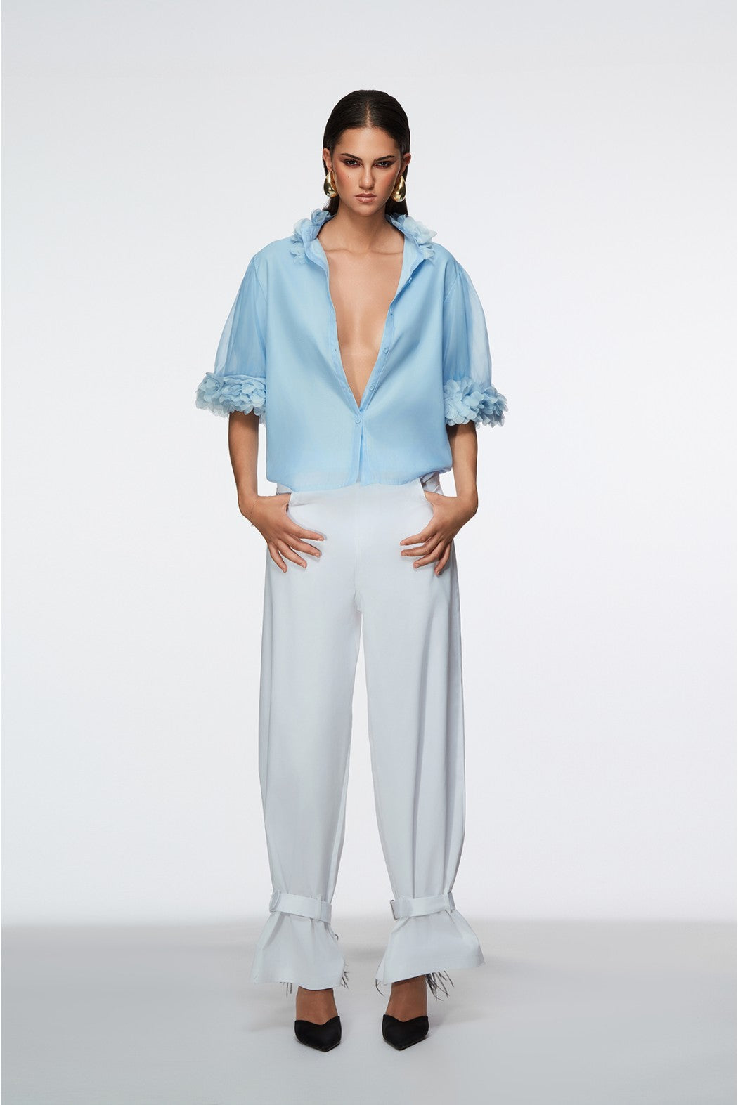 Woman wearing a light blue outfit with a white background