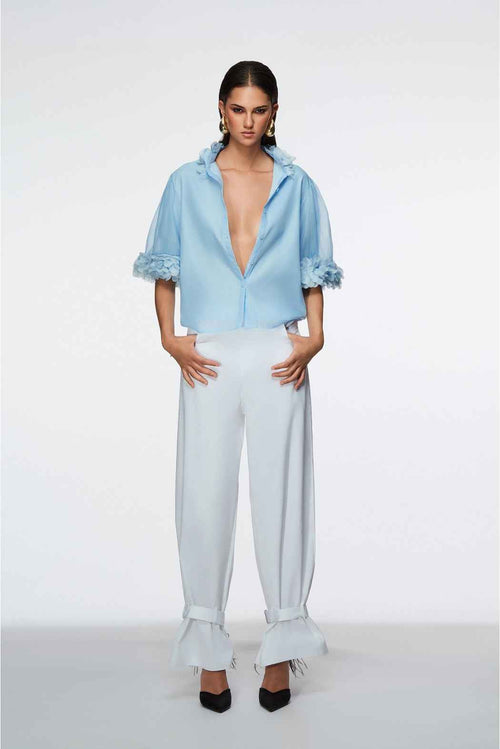 Woman wearing a light blue outfit with a white background