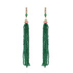 Pair of green beaded tassel earrings on a white background