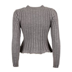 A gray ribbed knit long-sleeve top with structured shoulders and a cropped, slightly asymmetrical hem, shown against a plain white background.
