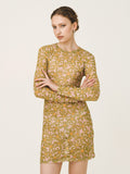 Woman wearing a patterned dress on a plain background