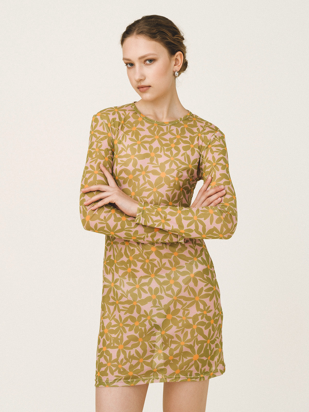 Woman wearing a patterned dress on a plain background