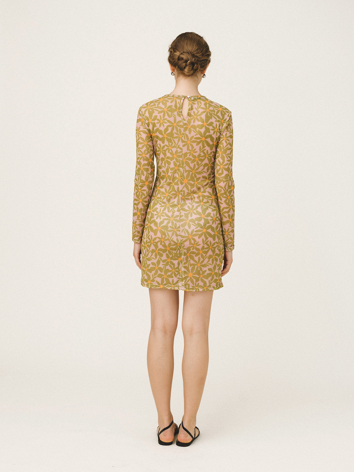 Woman wearing a patterned dress on a white background