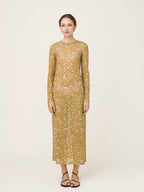 Woman wearing a yellow floral dress on a white background